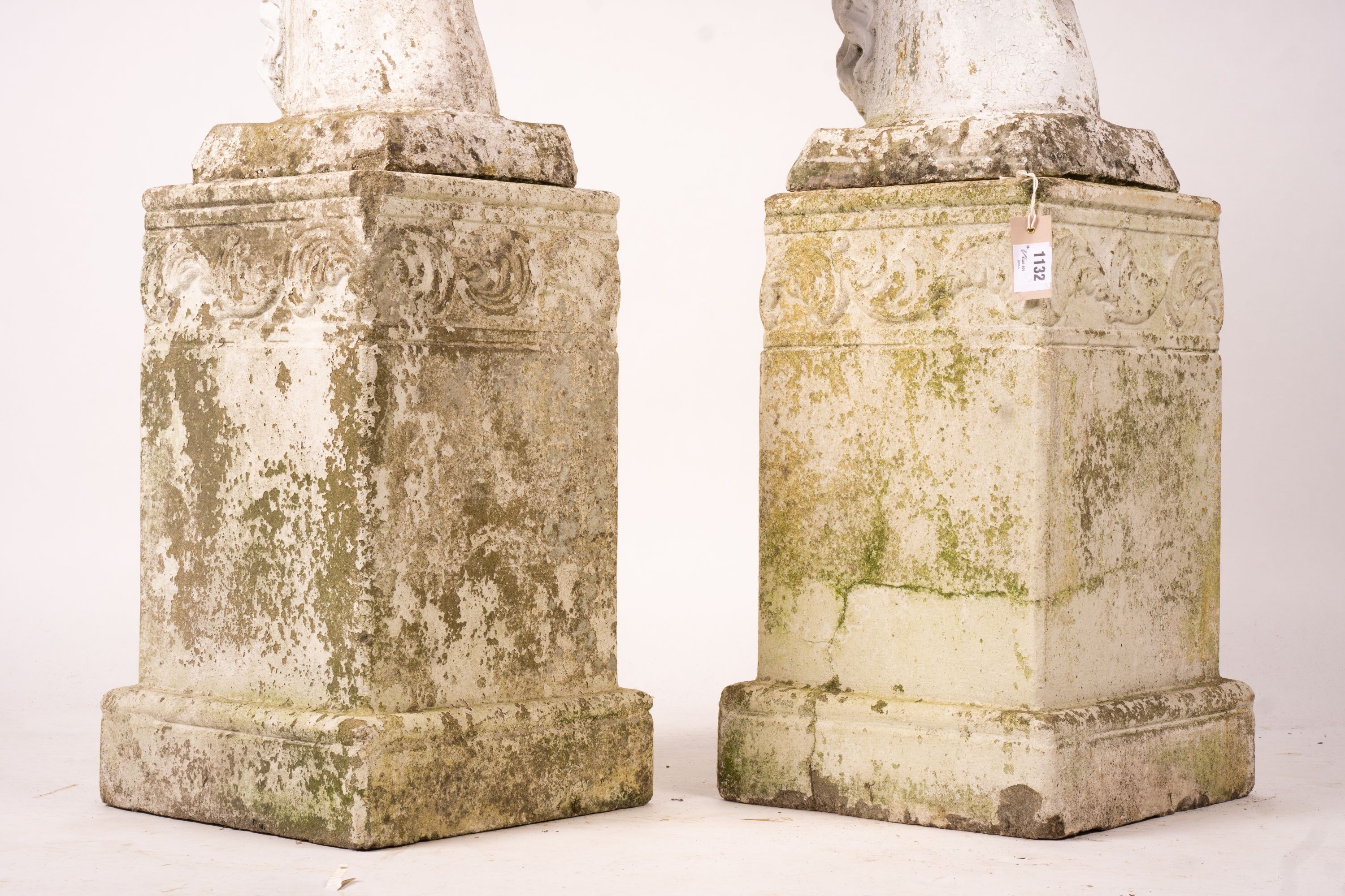 A pair of reconstituted stone horse's heads on plinth bases in the style of Austin and Seeley, height 104cm